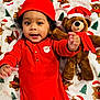 Reginald joined the competition — help win amazing prizes! baby, child, red_clothing, red_hat, plush_toy, teddy_bear, santa_hat, holiday_theme, festive_blanket, smiling, cute, indoor, portrait, infant, holiday_season, christmas, soft_toy, lying_down, happy, cozy