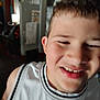 Mycah is registered to the contest to win money with this photo: child, boy, smile, face, portrait, indoor, jersey, clothing, short_hair, happy, closeup, person, young, casual, expression, background, room, light, blur, fun
