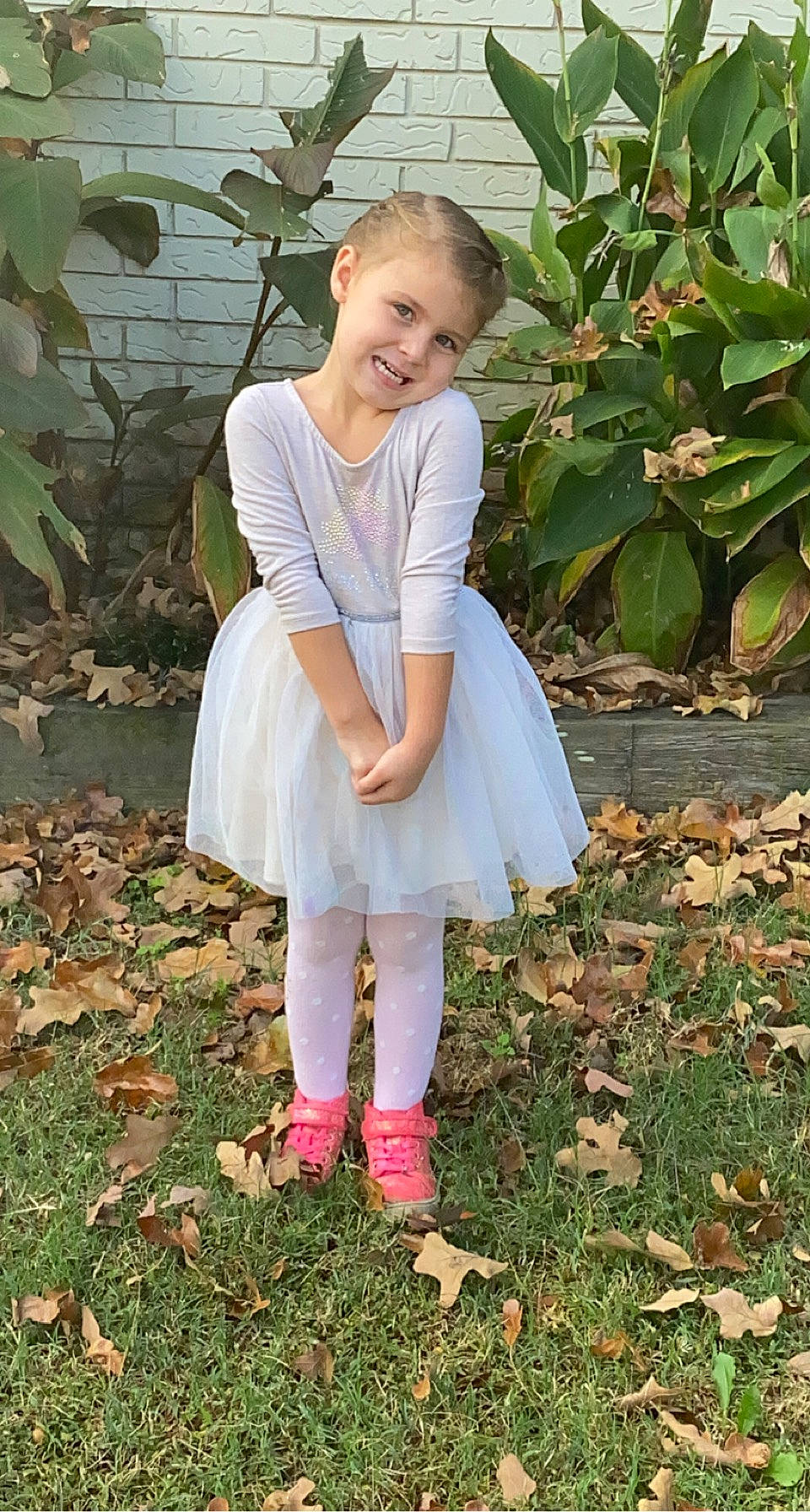 Nova is registered to the contest to win money with this photo: child, day_dress, fashion_accessory, formal_wear, garden, grass, happy, human_leg, joy, knee, pattern, people_in_nature, person, plant, sandal, shoe, sitting, sleeve, smile, spring