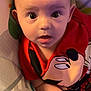 Khaison joined the competition — help win amazing prizes! baby, child, infant, face, wide_eyes, mickey_mouse, red_shirt, cushion, seat, curious, surprised, indoors, person, close_up, head, skin, clothing, young_child, expression, baby_girl_or_boy