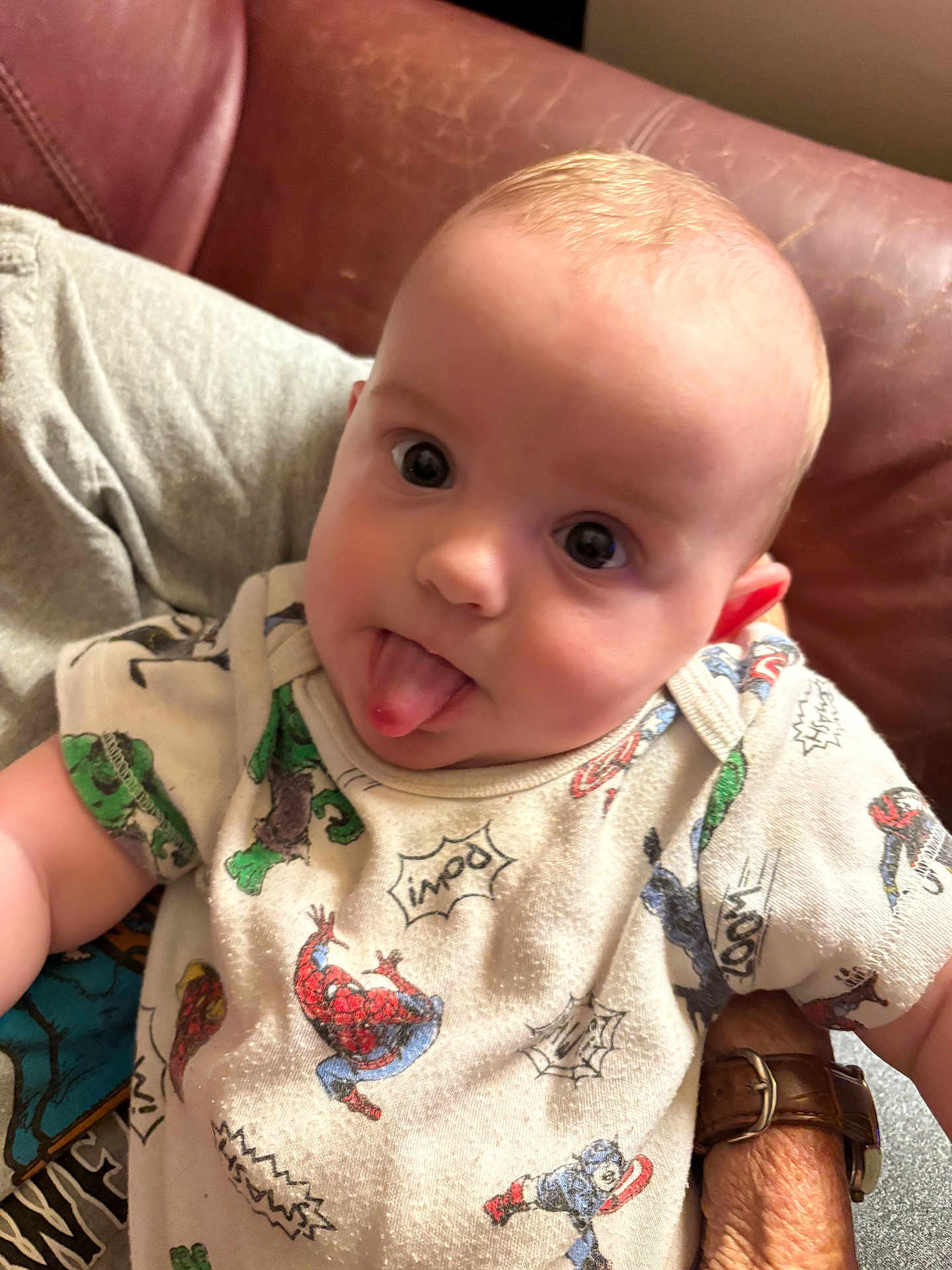 Khaison joined the competition — help win amazing prizes! baby, tongue_out, onesie, superhero, spiderman, captain_america, couch, leather, hand, adult, person, child, cute, playful, indoor, clothing, face, head, smile, infant
