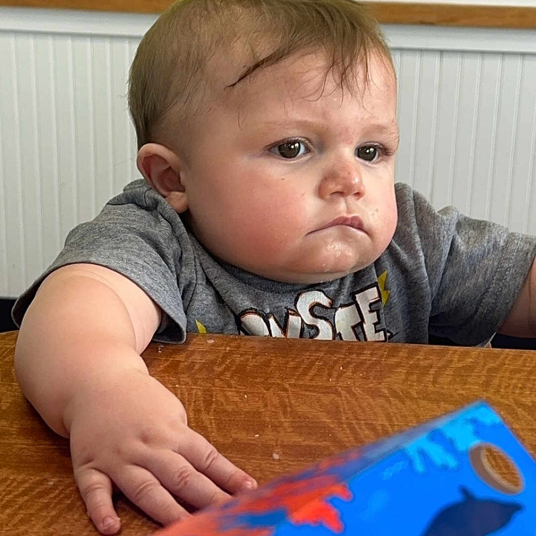 Jacob joined the competition — help win amazing prizes! baby, bodypart, clothing, couch, diningtable, face, finger, furniture, hand, hardwood, head, indoors, interiordesign, person, photography, portrait, sitting, t_shirt, table, wood