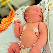 Ryder is registered to the contest to win money with this photo: baby, blanket, child, colorful, cute, diaper, fabric, healthcare, indoor, infant, medical_sensors, monitoring, newborn, peaceful, polka_dots, relaxation, resting, skin, sleeping, soft_focus