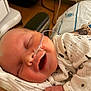 Ryder is registered to the contest to win money with this photo: baby, bed, caregiver, closeup, comfort, face, hand, healthcare, hospital, hospital_wristband, infant, medical_equipment, medical_tube, nasal_cannula, newborn, person, skin, sleeping, smiling, white_clothing