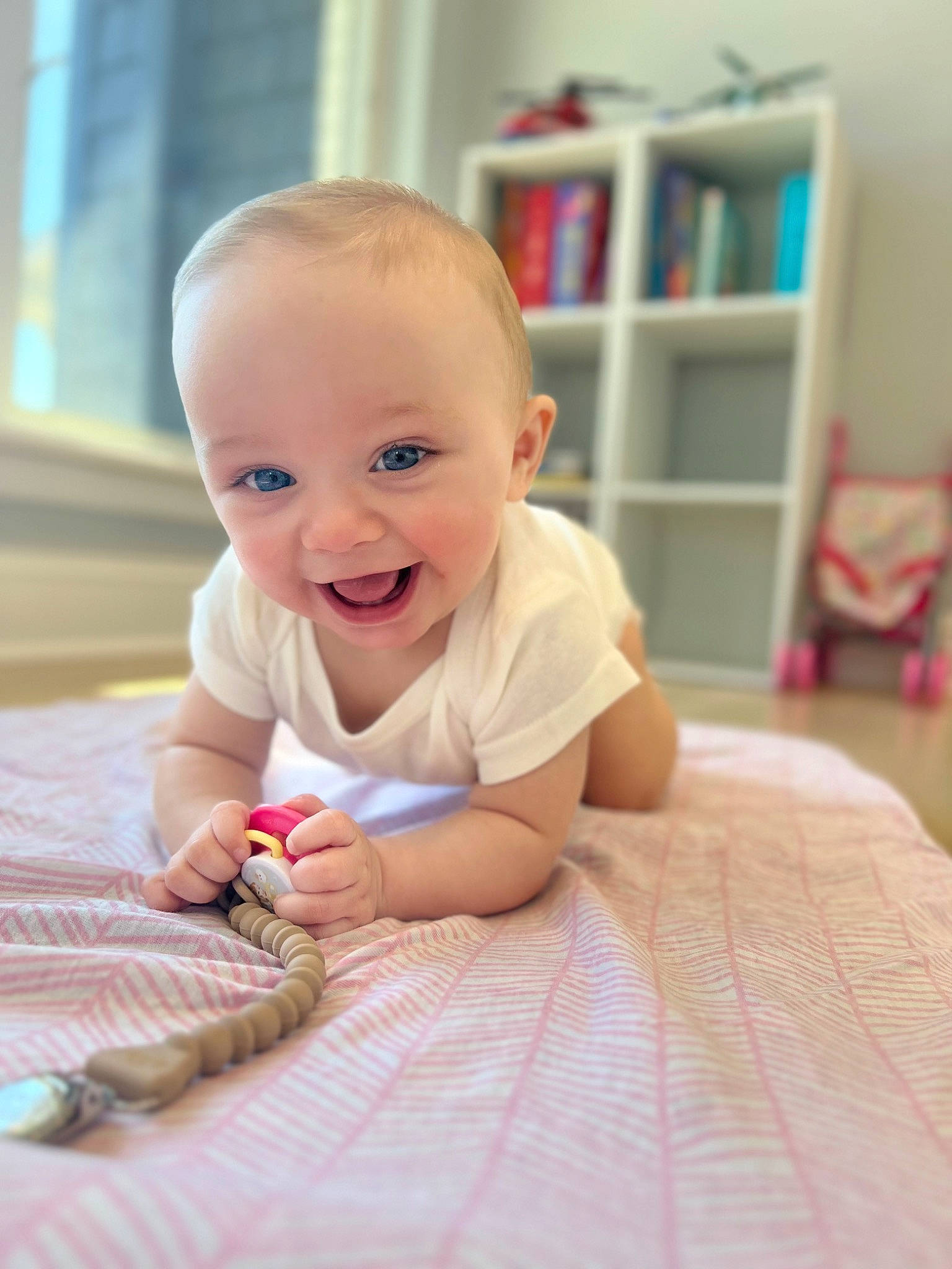 Leilani is registered to the contest to win money with this photo: baby, baby_toddler_clothing, bookcase, cheek, chin, comfort, eye, face, facial_expression, flooring, fun, hairstyle, happy, iris, joy, person, shelf, skin, sleeve, smile