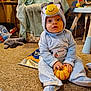 Brentlee joined the competition — help win amazing prizes! baby, child, costume, blue, bird, pumpkin, carpet, indoor, toy, blanket, chair, cute, sitting, floor, hand, face, expression, sock, cozy, curious