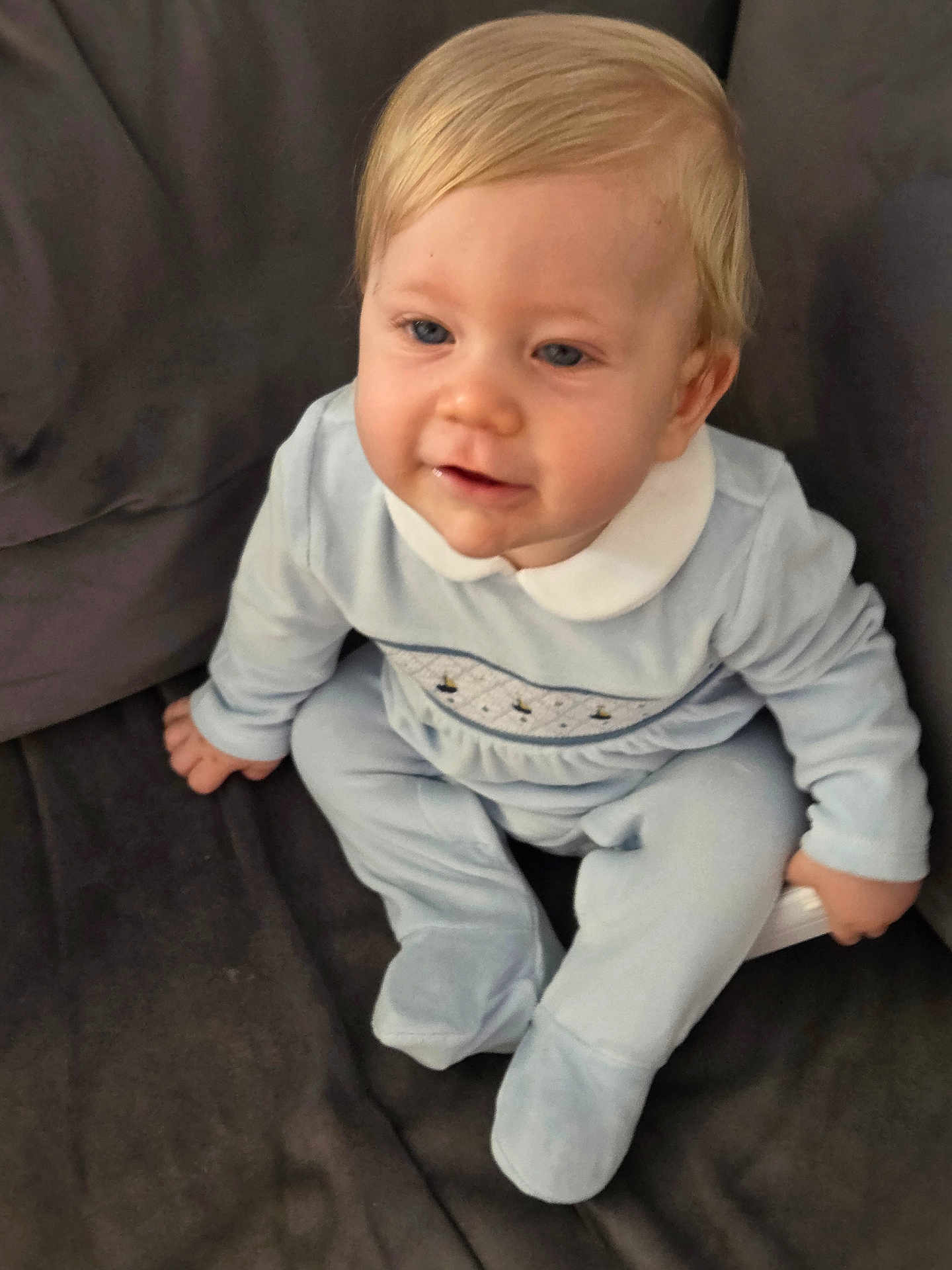 Cole joined the competition — help win amazing prizes! baby, child, infant, blue_outfit, white_collar, sitting, couch, indoor, portrait, young_child, cute, soft_fabric, light_hair, face, person, casual_clothing, cozy, comfortable, smiling, young