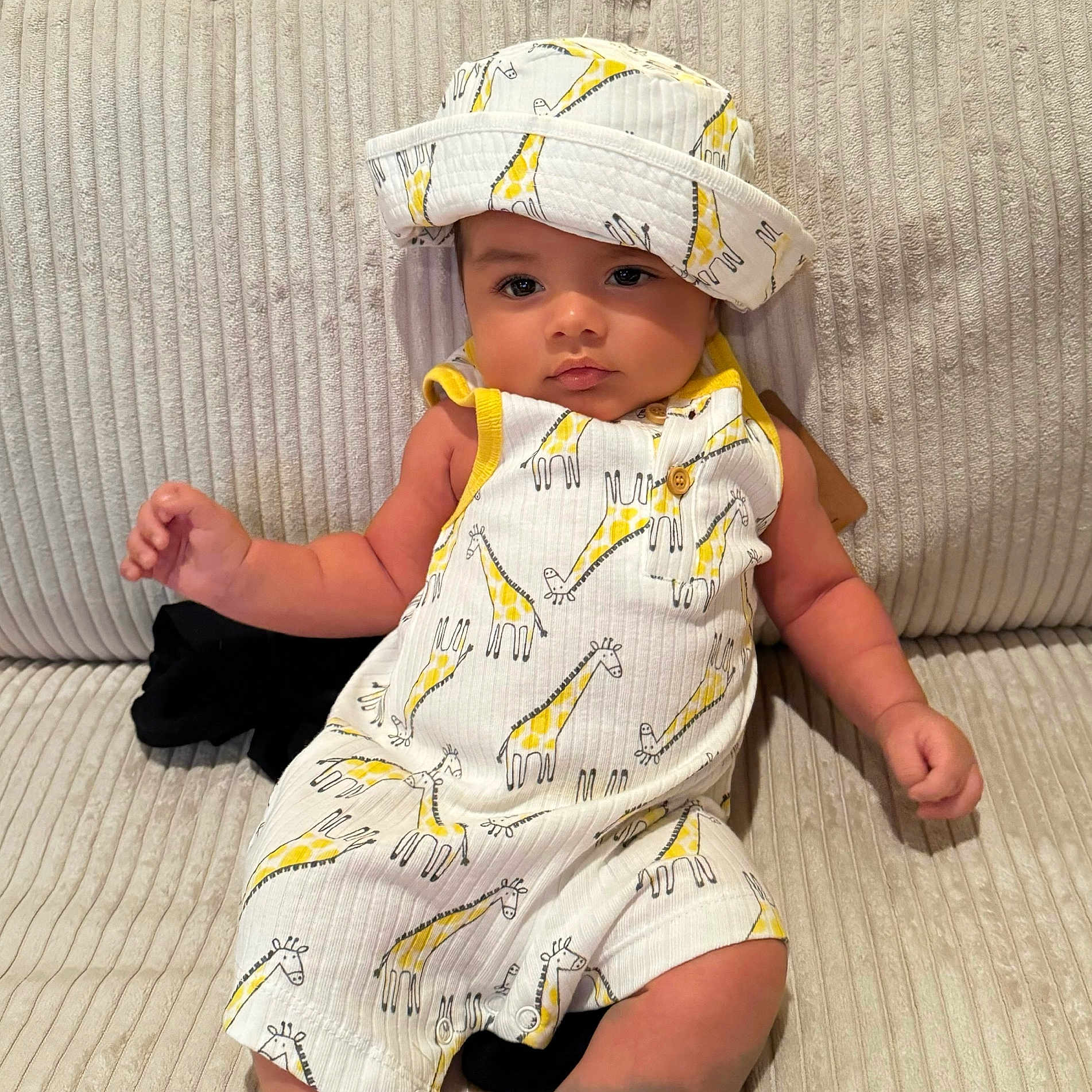 Bentley joined the competition — help win amazing prizes! baby, beachwear, bonnet, cap, clothing, couch, dress, face, furniture, hat, head, person, photography, portrait, sitting, sleeve, toy