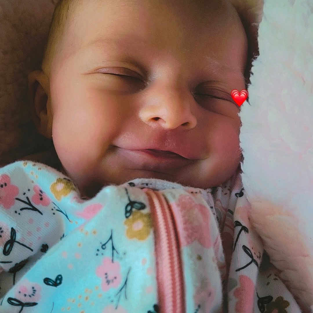 Raylin joined the competition — help win amazing prizes! baby, blanket, child, closeup, cozy, cute, face, floral_pattern, happy, head, indoors, infant, newborn, onesie, peaceful, portrait, resting, sleeping, smiling, soft_texture