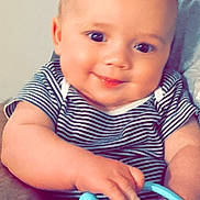 Bryson is registered to the contest to win money with this photo: baby, bodypart, clothing, couch, cup, cushion, face, furniture, happy, head, homedecor, laughing, newborn, person, photography, portrait, pottery, sitting, smile, t_shirt