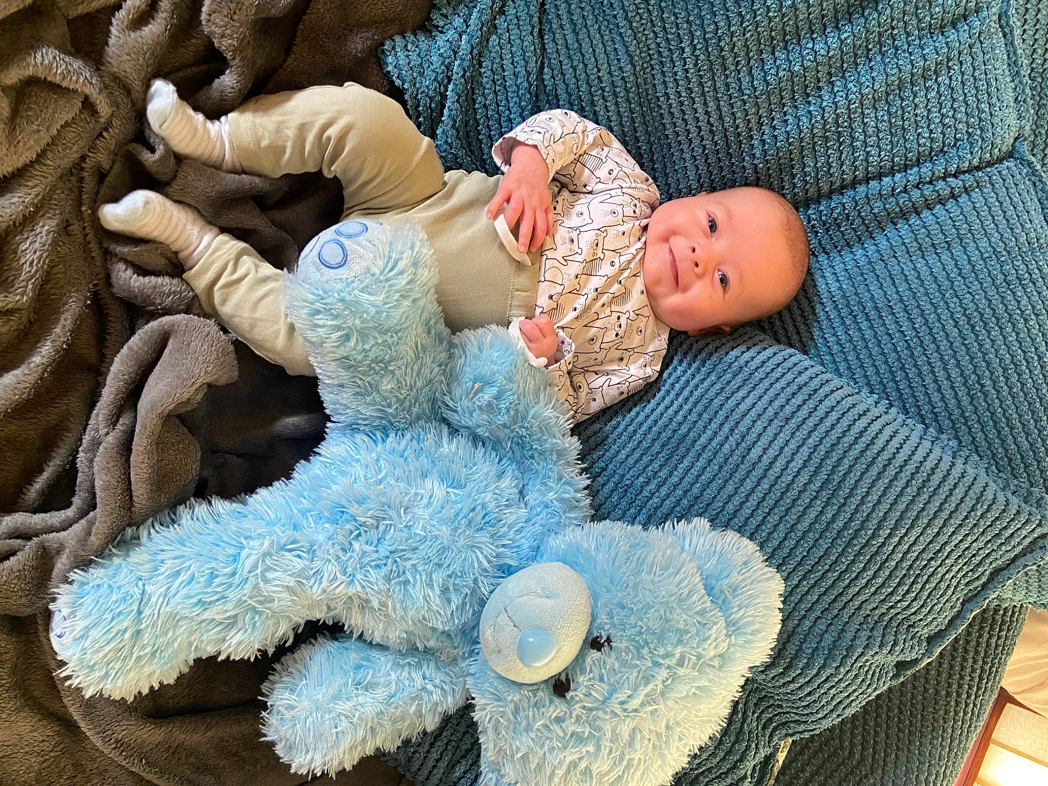 Archie is registered to the contest to win money with this photo: azure, baby, baby_products, baby_sleeping, baby_toddler_clothing, comfort, craft, doll, electric_blue, eye, fashion_accessory, fur, joy, knit_cap, linens, pattern, person, sitting, textile, toddler