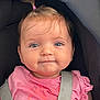 baby, child, girl, car_seat, pink_shirt, pony_tail, blue_eyes, smile, face, infant, clothing, seatbelt, cute, person, portrait, young_child, hair, expression, sitting, indoor