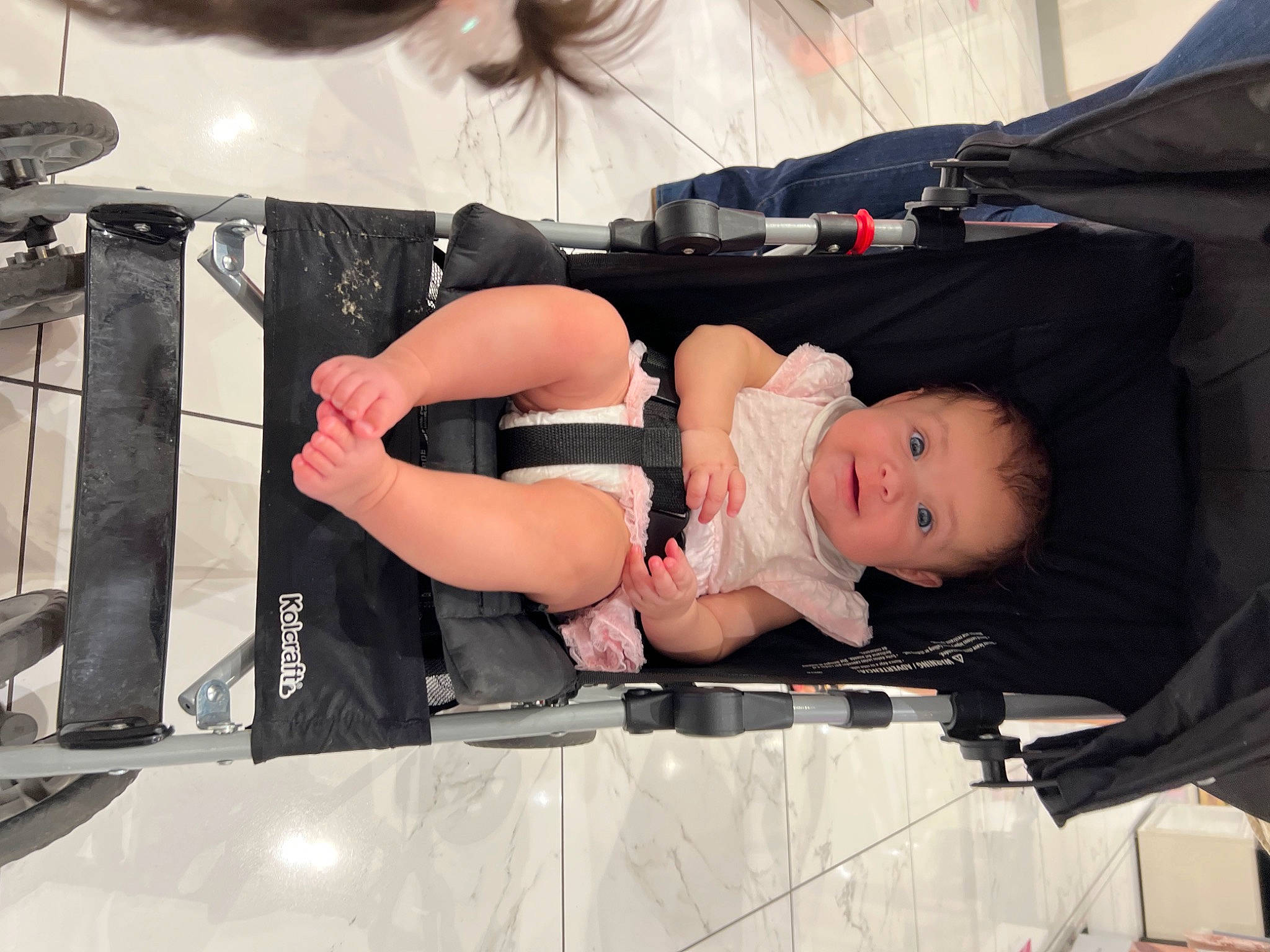 Kayle is registered to the contest to win money with this photo: audio_equipment, auto_part, automotive_design, automotive_exterior, baby, baby_carriage, baby_products, bumper, child, comfort, costume, fun, human_leg, person, room, sitting, t_shirt, thigh, toddler