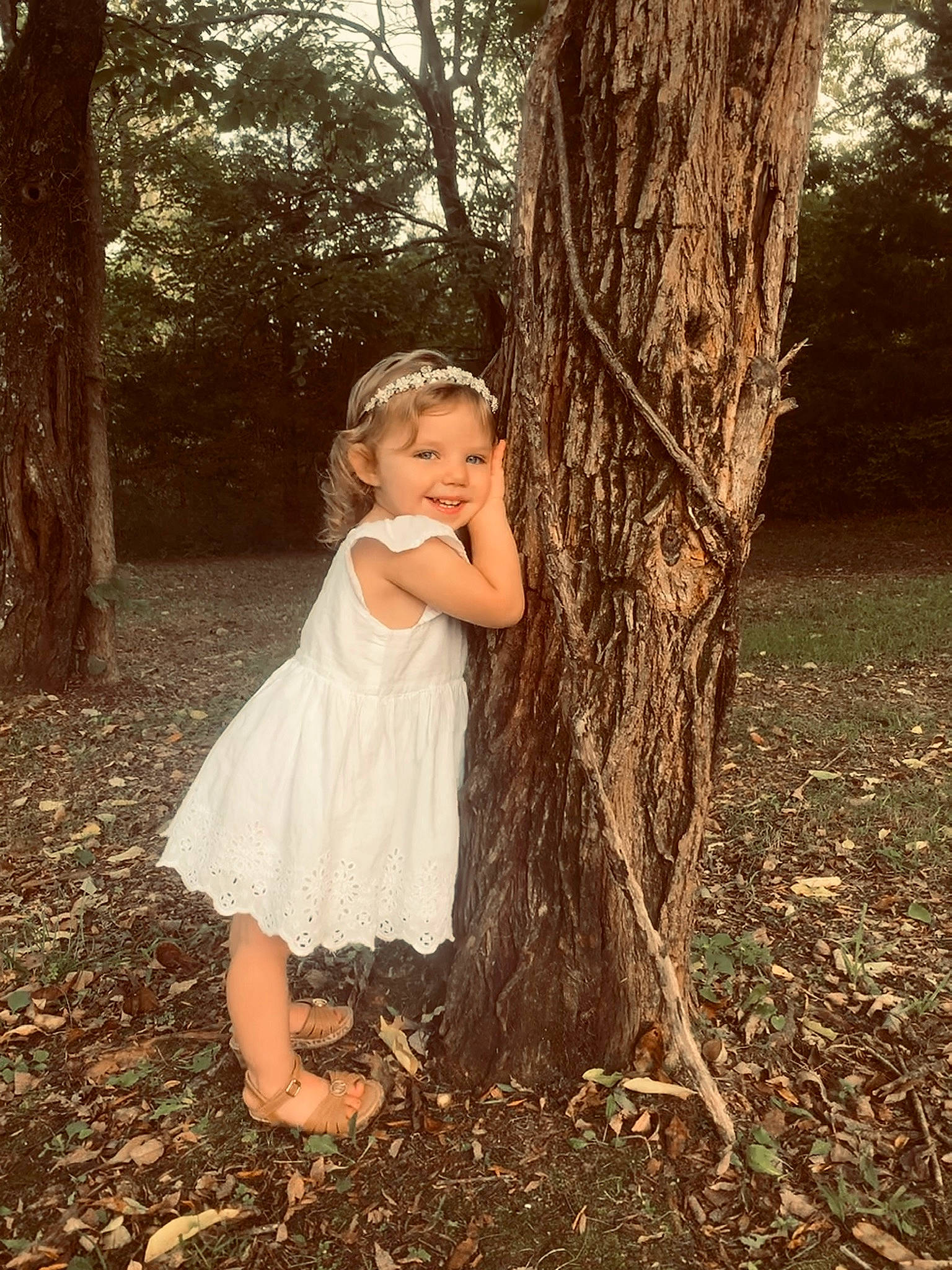 Matilda is registered to the contest to win money with this photo: branch, dress, eye, flash_photography, forest, fun, grass, hair, happy, joy, leg, long_hair, natural_environment, people_in_nature, person, plant, smile, tints_and_shades, tree, trunk