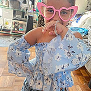 Luna is registered to the contest to win money with this photo: accessories, baby, blouse, clothing, costume, face, glasses, goggles, hat, head, indoors, jewelry, necklace, pants, person, photoframe, photography, portrait, shorts, sunglasses