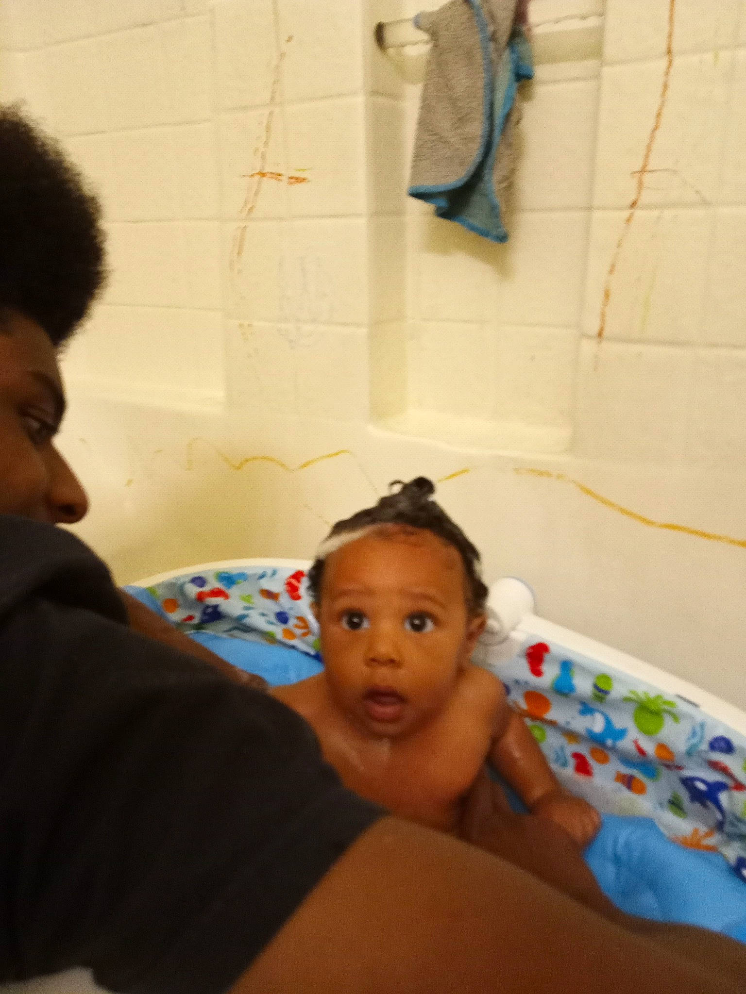 Heir is registered to the contest to win money with this photo: baby, bathing, bathtub, birth, child, ear, fun, neck, person, room, skin, surprise, toddler, vacation