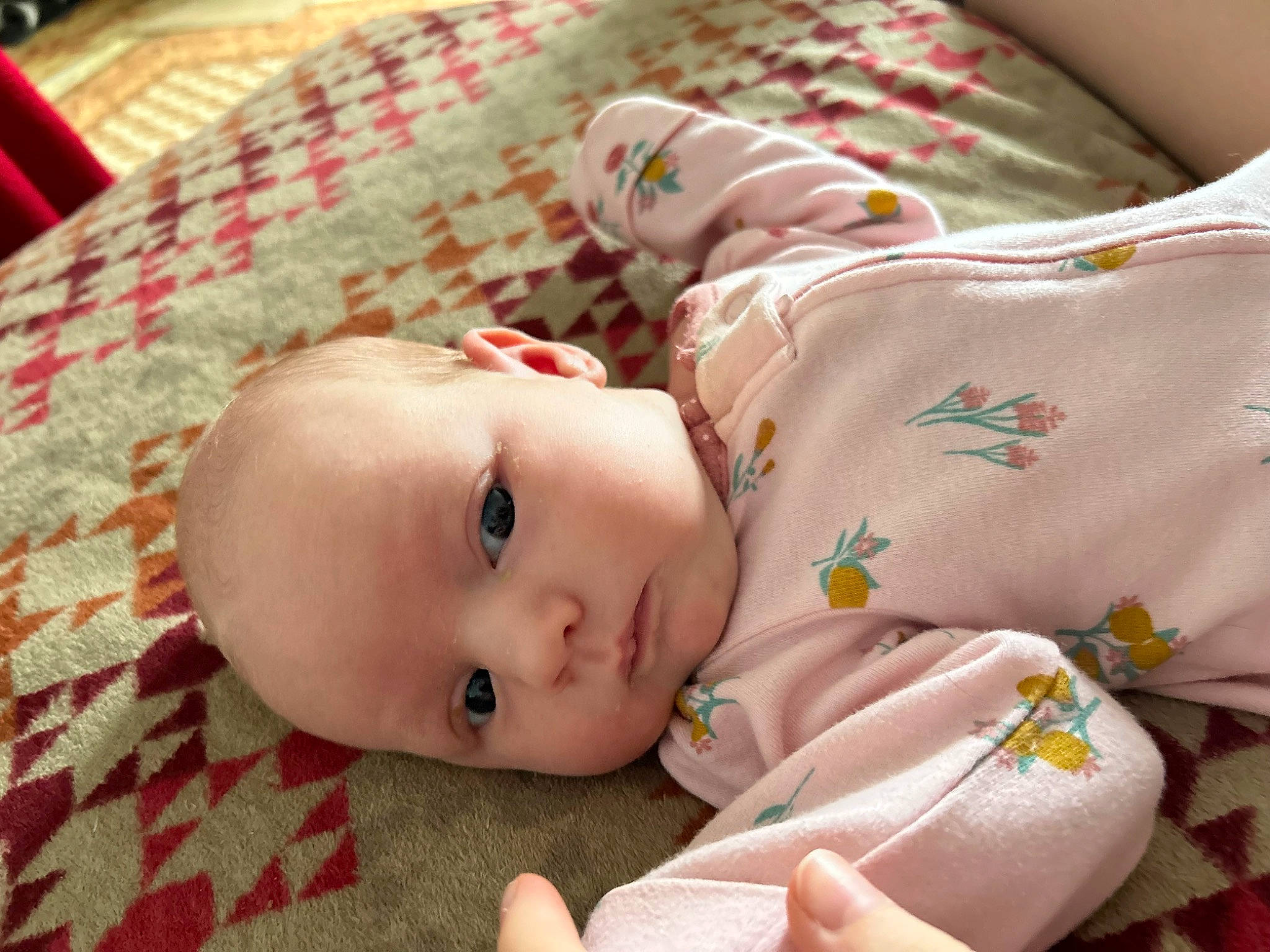 Bella is registered to the contest to win money with this photo: baby, baby_products, baby_toddler_clothing, bedding, bedtime, cheek, child, comfort, eyelash, flooring, fur, grass, linens, pattern, person, portrait_photography, skin, sleeve, textile, toddler