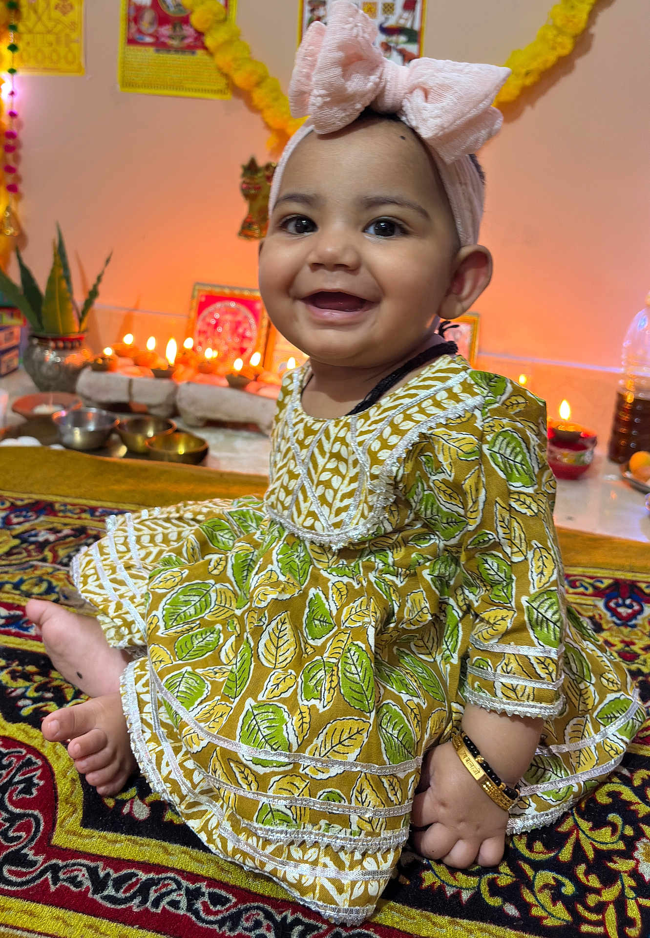 Vamika joined the competition — help win amazing prizes! baby, child, smiling, headband, dress, patterned_clothing, carpet, indoors, decorations, candles, festive, happy, cute, jewelry, bracelet, sitting, portrait, celebration, colorful, infant
