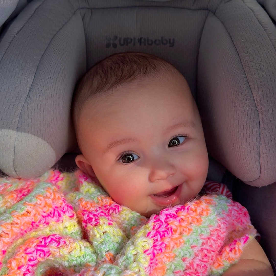 Paisley joined the competition — help win amazing prizes! baby, blanket, car_seat, child, clothing, colorful, comfort, crochet, cute, eyes, face, hands, happy, indoors, infant, newborn, portrait, smile, soft, warm