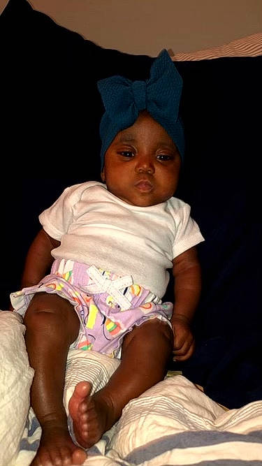 Gracelyn is registered to the contest to win money with this photo: baby, bonnet, child, headgear, headwear, human, person, sitting, smile, toddler