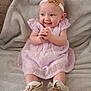 baby, smiling, dress, headband, shoes, sitting, blanket, happy, infant, child, cute, clothing, footwear, portrait, indoor, soft_texture, young_child, skin, person, baby_girl