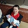 Karoleena joined the competition — help win amazing prizes! baby, blanket, boy, child, clothing, couch, face, family, happy, hat, holding, indoor, jacket, newborn, person, portrait, red_shirt, seated, sibling, smile