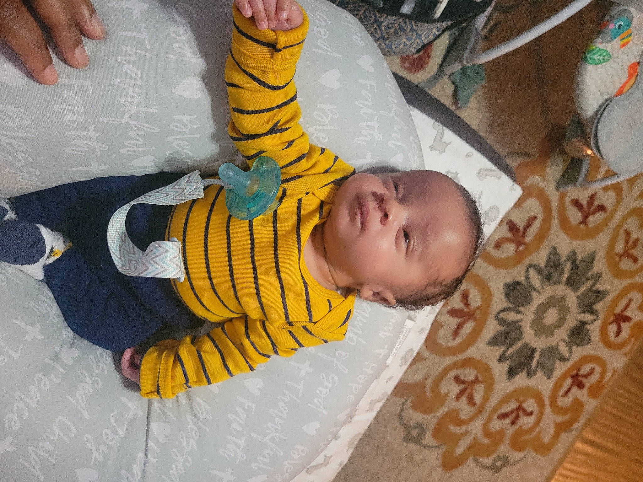 Tylen joined the competition — help win amazing prizes! baby, baby_toddler_clothing, child, comfort, finger, flooring, foot, fun, gesture, happy, human_body, human_leg, linens, pattern, person, sitting, thumb, toddler, toy, wood