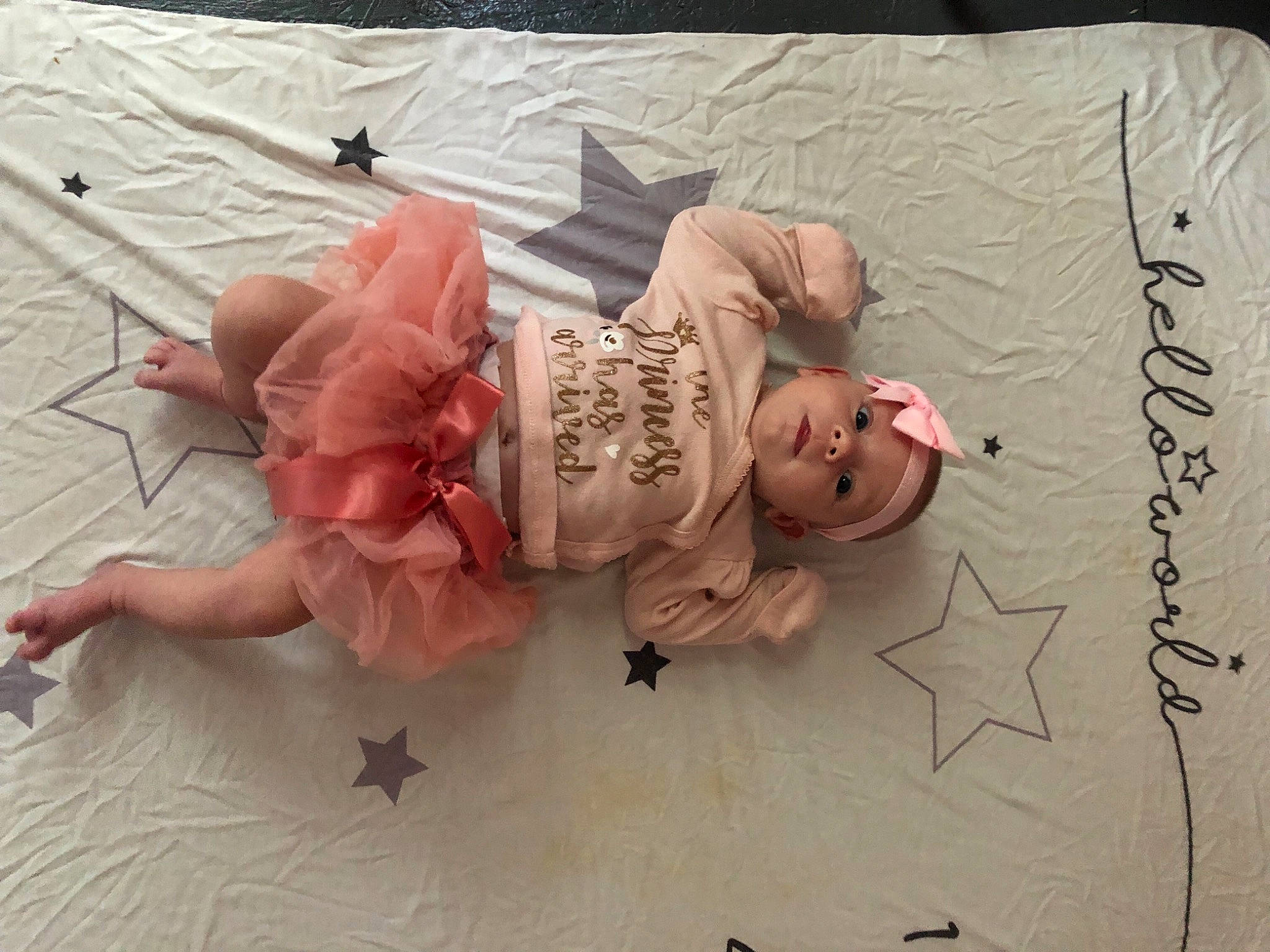 Genevieve is registered to the contest to win money with this photo: art, child, comfort, fashion_accessory, flesh, flooring, headpiece, headwear, linens, paper, paper_product, pattern, peach, person, petal, pink, room, rose, wood, wrist