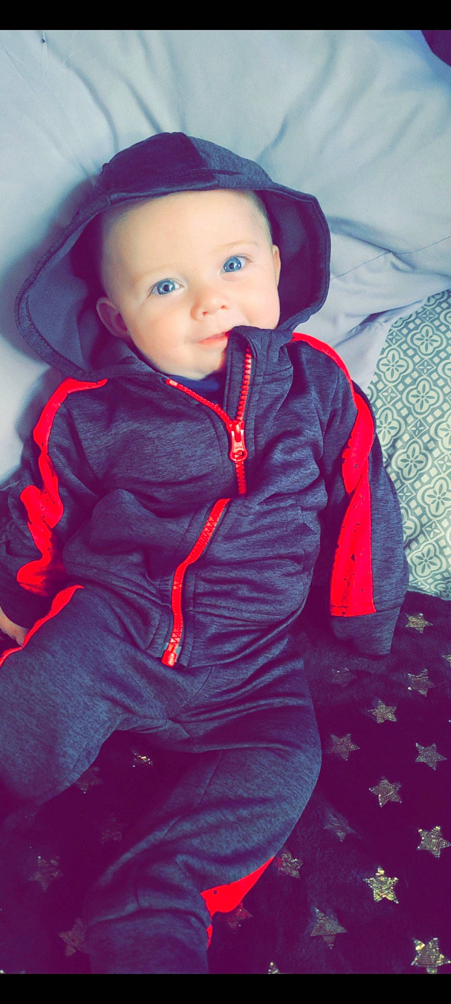 Brixton is registered to the contest to win money with this photo: baby, baby_toddler_clothing, cheek, child, comfort, cool, electric_blue, eye, eyebrow, face, flash_photography, happy, iris, lip, magenta, nose, person, sitting, sleeve, smile