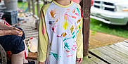 Emma joined the competition — help win amazing prizes! adult, car, casual, child, daylight, expression, footwear, grass, hair, happy, outdoor, paint, person, porch, shirt, slippers, smiling, tree, vehicle, wood