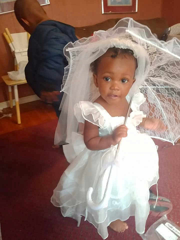 Genesis joined the competition — help win amazing prizes! toddler, child, dress, white_dress, veil, umbrella, indoor, carpet, barefoot, curious, girl, blue_jacket, child_back, room, furniture, wooden_chair, curtain, portrait, people, floor