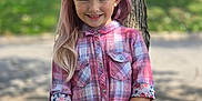 Charlotte is registered to the contest to win money with this photo: child, girl, smile, plaid_shirt, denim_shorts, tree, outdoor, grass, hair_clip, happy, portrait, cute, summer, nature, casual_clothing, standing, young, fashion, sunlight, background_blur