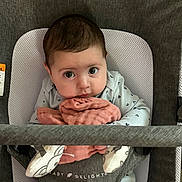 Harley joined the competition — help win amazing prizes! baby, baby_seat, blanket, bouncer, child, close_up, curious_expression, cute, eyes, face, gray_fabric, hands, indoor, infant, looking_at_camera, onesie, pink_cloth, plush_toy, portrait, soft_texture