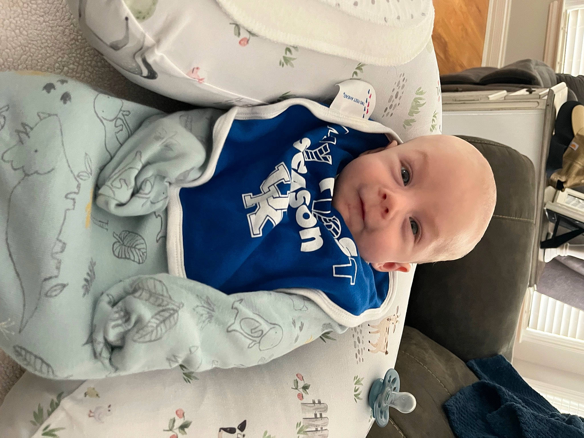 Louie is registered to the contest to win money with this photo: baby, baby_products, baby_safety, baby_sleeping, baby_toddler_clothing, child, comfort, cup, dishware, drinkware, linens, pattern, person, porcelain, room, serveware, shelf, sitting, sleeve, toddler