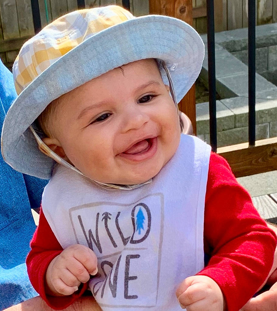 Casen joined the competition — help win amazing prizes! baby, baby_toddler_clothing, cap, eye, face, facial_expression, finger, gesture, happy, hat, head, headgear, headwear, lip, mouth, outerwear, person, skin, sleeve, smile