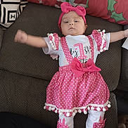 Everleigh joined the competition — help win amazing prizes! architecture, baby, bonnet, building, cap, clothing, costume, couch, cushion, dress, face, furniture, hat, head, homedecor, indoors, livingroom, pattern, person, room