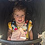 Everleigh is registered to the contest to win money with this photo: baby, blanket, blue_eyes, child, colorful_clothing, curly_hair, cute, happy, harness, outdoor, penguin_design, pink_blanket, puggle_brand, safety_bar, seated, smiling, stroller, sunlight, toddler, yellow_clothing
