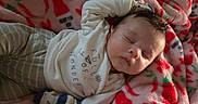 William is registered to the contest to win money with this photo: baby, sleeping, blanket, pajamas, mittens, infant, cozy, child, face, peaceful, cute, soft, resting, indoors, comfort, warm, person, portrait, toddler, sleep