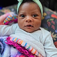 Camille joined the competition — help win amazing prizes! baby, infant, headband, blanket, colorful, closeup, portrait, cute, soft, texture, pattern, child, young, face, expression, clothing, warm, cozy, indoor, person
