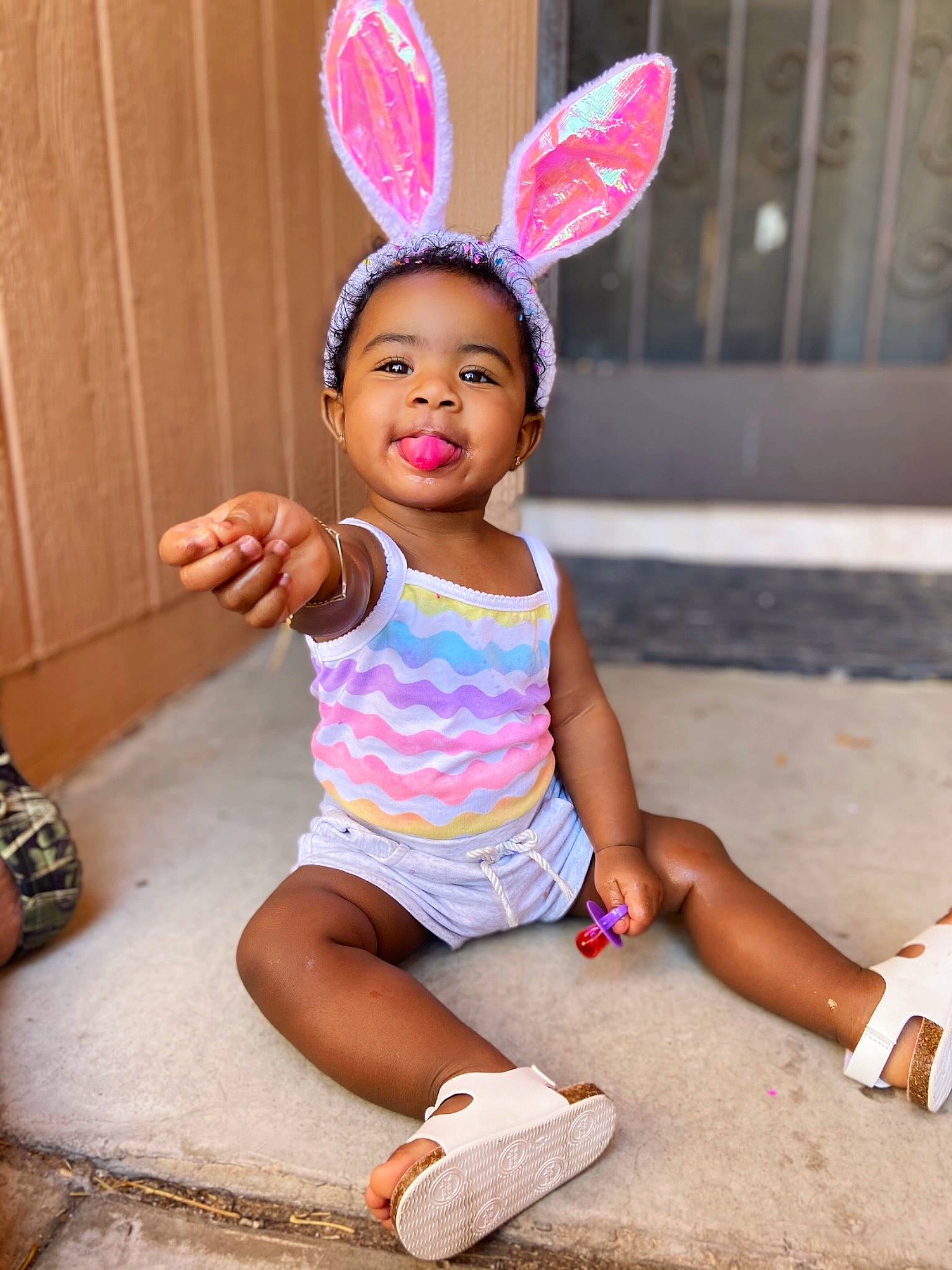 Jaida is registered to the contest to win money with this photo: baby_toddler_clothing, clothing, ear, facial_expression, finger, footwear, hairstyle, happy, head, human, joy, leg, mammal, neck, person, pink, shoe, shorts, skin, sleeve