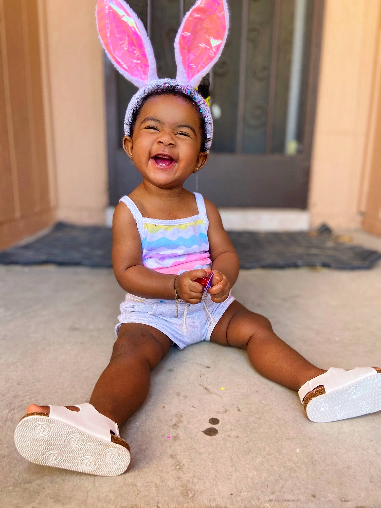 Jaida is registered to the contest to win money with this photo: baby_toddler_clothing, barefoot, costume_hat, door, event, facial_expression, foot, fun, happy, human_leg, knee, magenta, person, pink, shoe, shorts, smile, sneakers, thigh, toddler