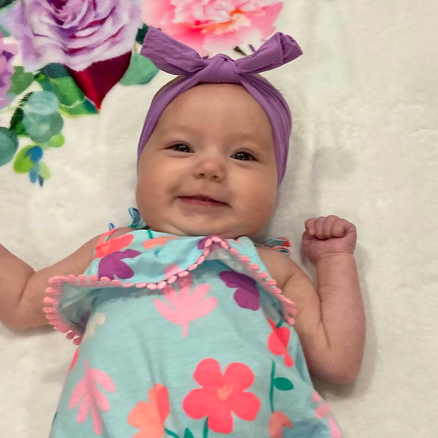 Sydney is registered to the contest to win money with this photo: baby, baby_toddler_clothing, dress, face, flower, happy, head, headband, headpiece, headwear, joy, magenta, outerwear, pattern, person, petal, pink, plant, skin, sleeve