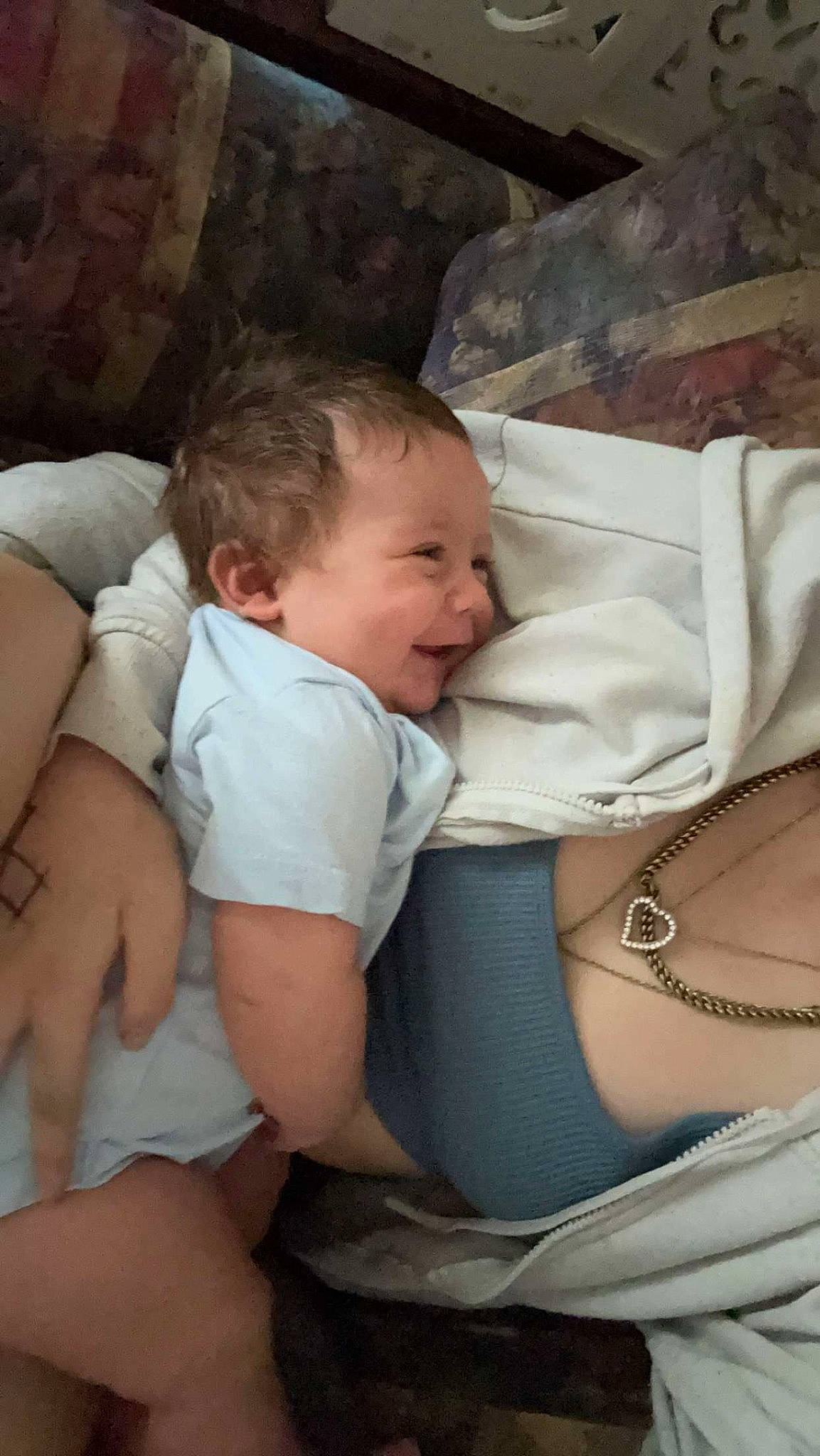 Leon is registered to the contest to win money with this photo: abdomen, baby, baby_toddler_clothing, cheek, child, comfort, elbow, eye, finger, fun, human_leg, iris, lap, mouth, person, sitting, skin, textile, thigh, toddler