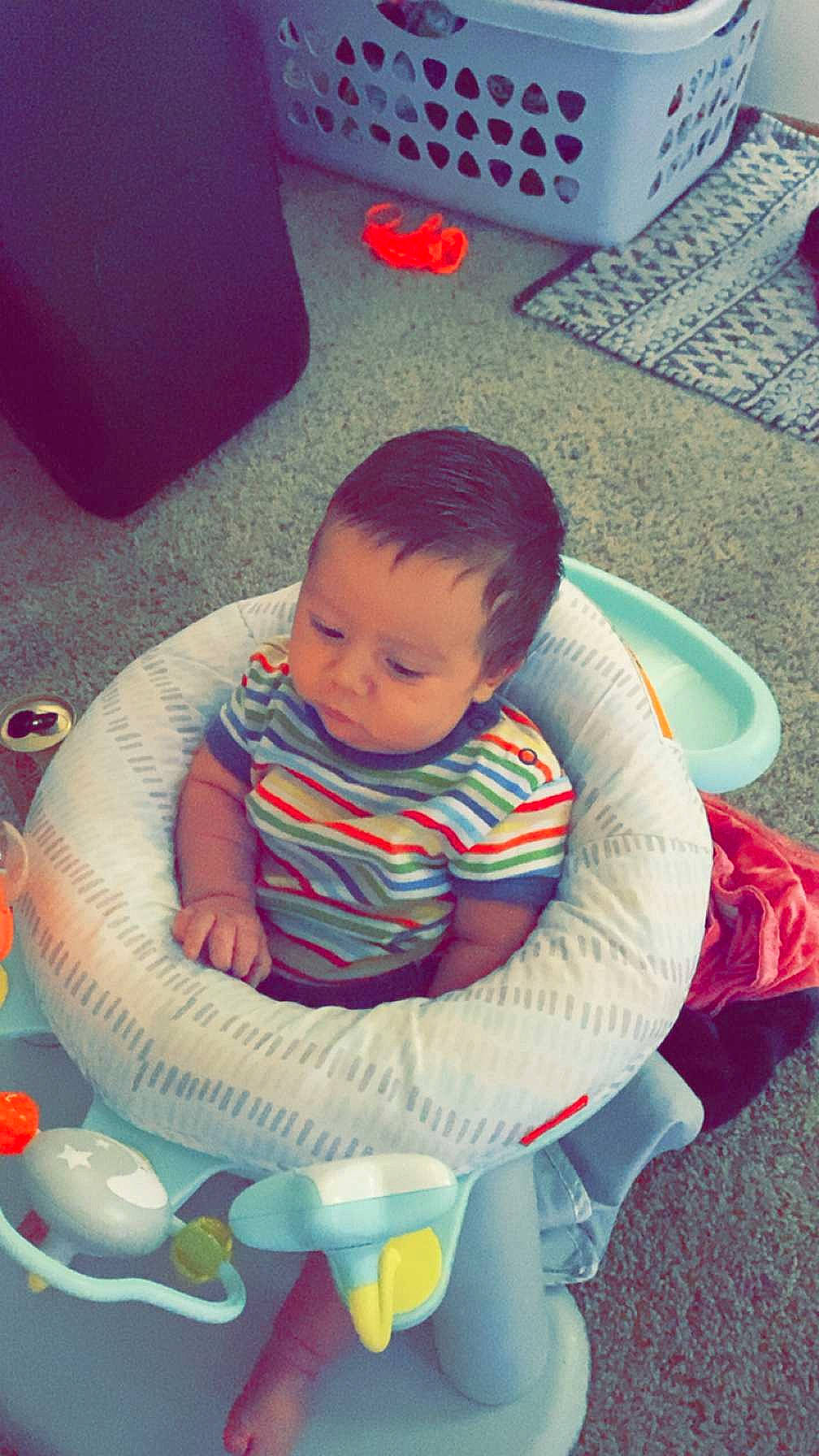 Leon is registered to the contest to win money with this photo: baby, baby_products, baby_toddler_clothing, baby_toys, chair, child, comfort, flooring, fun, grass, happy, lap, leisure, pattern, person, play, product, red, sitting, toddler