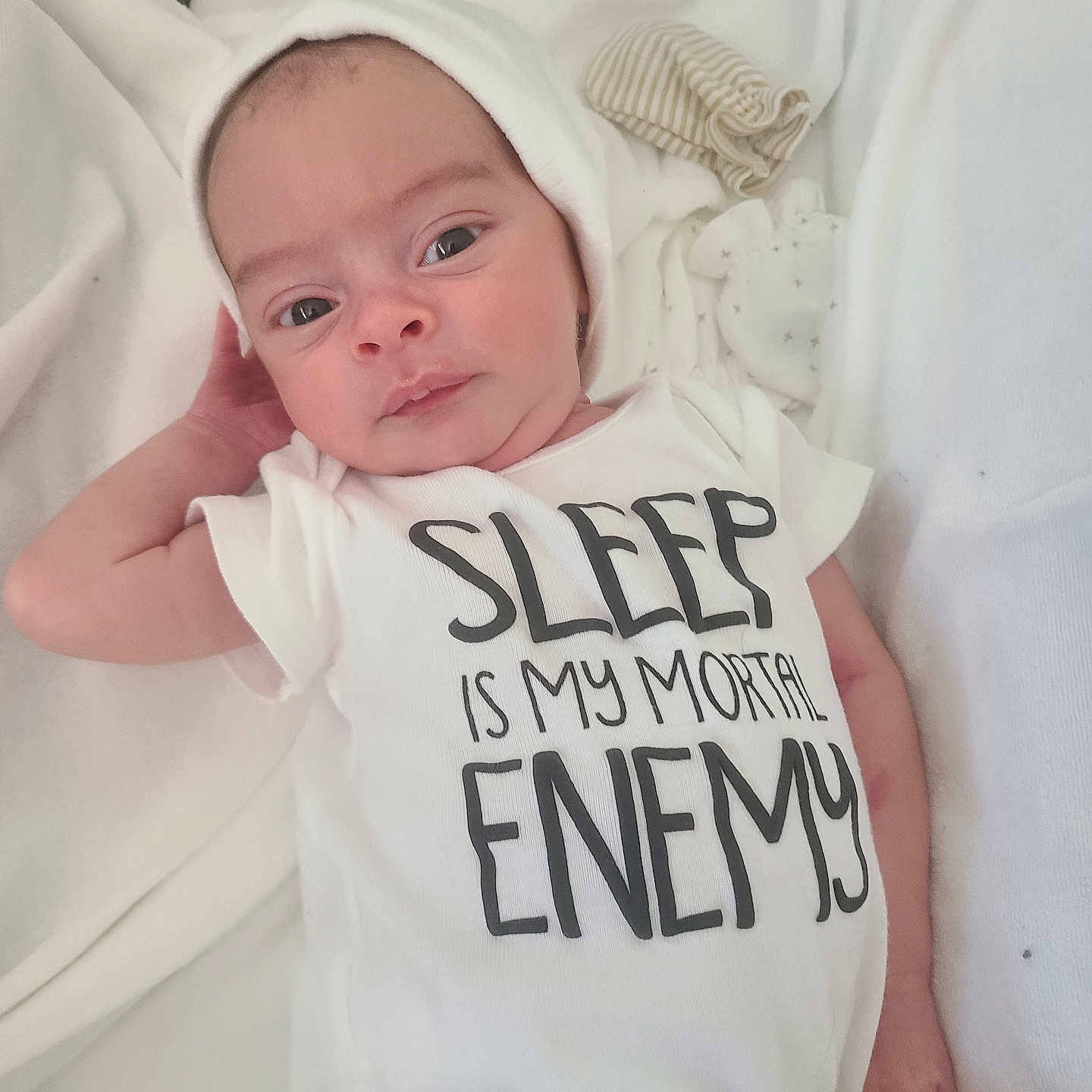 Orrin joined the competition — help win amazing prizes! newborn, baby, infant, child, portrait, sleeping, awake, onesie, white_clothing, hat, bed, bedding, blanket, indoor, closeup, face, eyes, hands, text_on_clothing, adorable