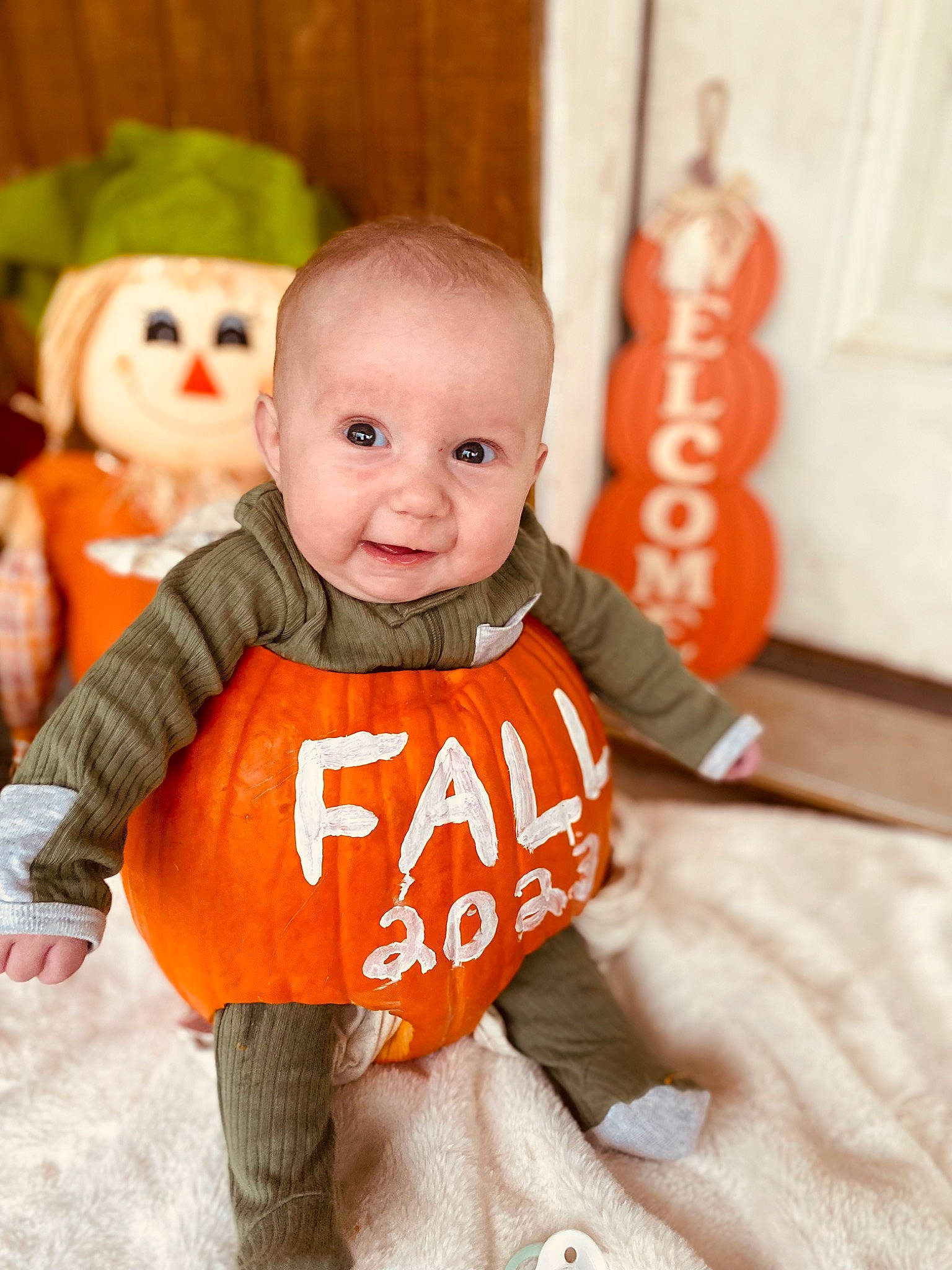 Lincoln joined the competition — help win amazing prizes! baby, baby_toddler_clothing, cheek, child, doll, eye, facial_expression, flooring, happy, head, human_body, nose, orange, person, skin, sleeve, smile, standing, toddler, toy