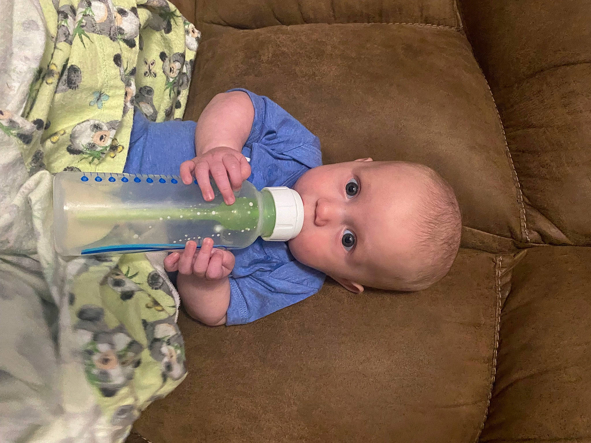 Lincoln is registered to the contest to win money with this photo: baby, baby_bottle, baby_products, baby_toddler_clothing, bottle, child, comfort, drinkware, eye, hand, human_body, infant_formula, iris, military_camouflage, nail, person, plastic_bottle, product, room, thumb