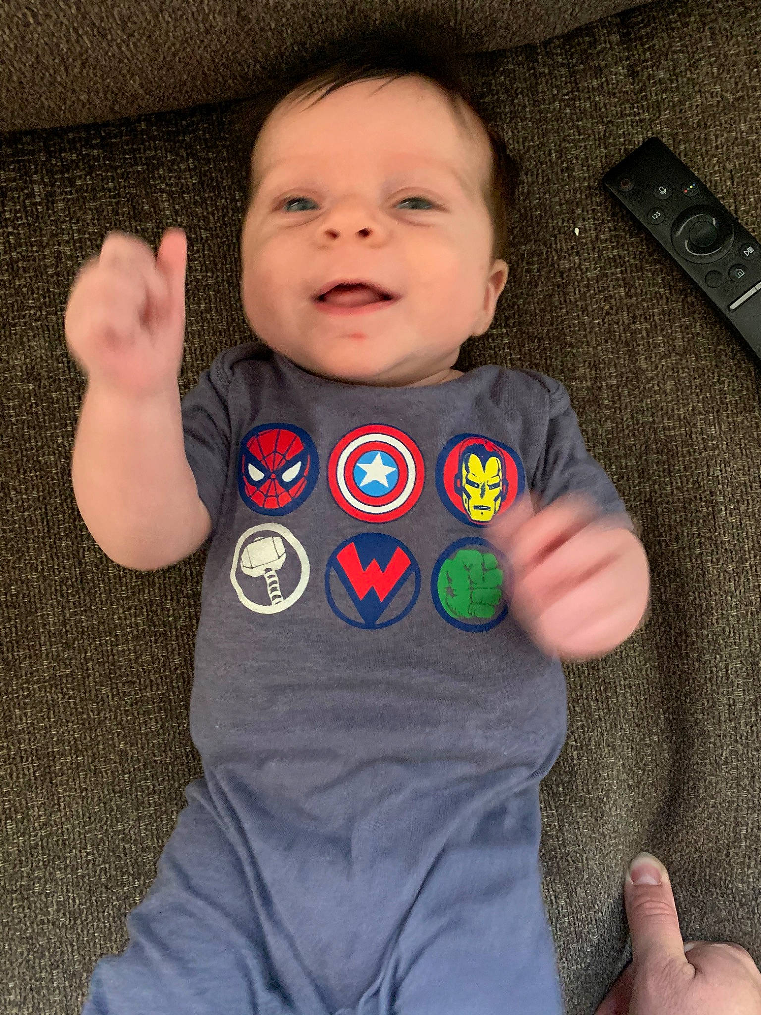 Shawn is registered to the contest to win money with this photo: baby, baby_products, baby_toddler_clothing, child, electronic_device, finger, gadget, game_controller, hand, person, play, product, skin, sleeve, t_shirt, technology, toddler