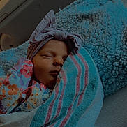 Paisleigh is registered to the contest to win money with this photo: newborn, baby, sleeping, blanket, headband, bow, floral_clothing, cozy, soft_texture, bed, pillow, infant, portrait, closeup, resting, cute, peaceful, indoor, warm_lighting, child