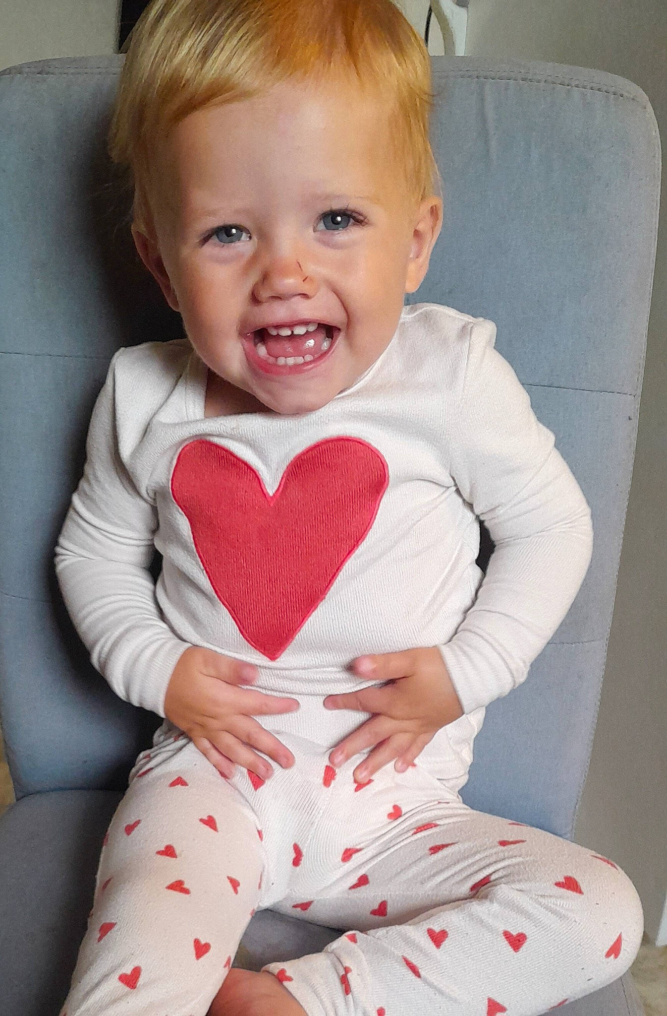 Allie is registered to the contest to win money with this photo: arm, baby, baby_toddler_clothing, cheek, chin, comfort, eye, finger, happy, head, human_body, iris, leg, lip, person, pink, skin, sleeve, smile, thigh